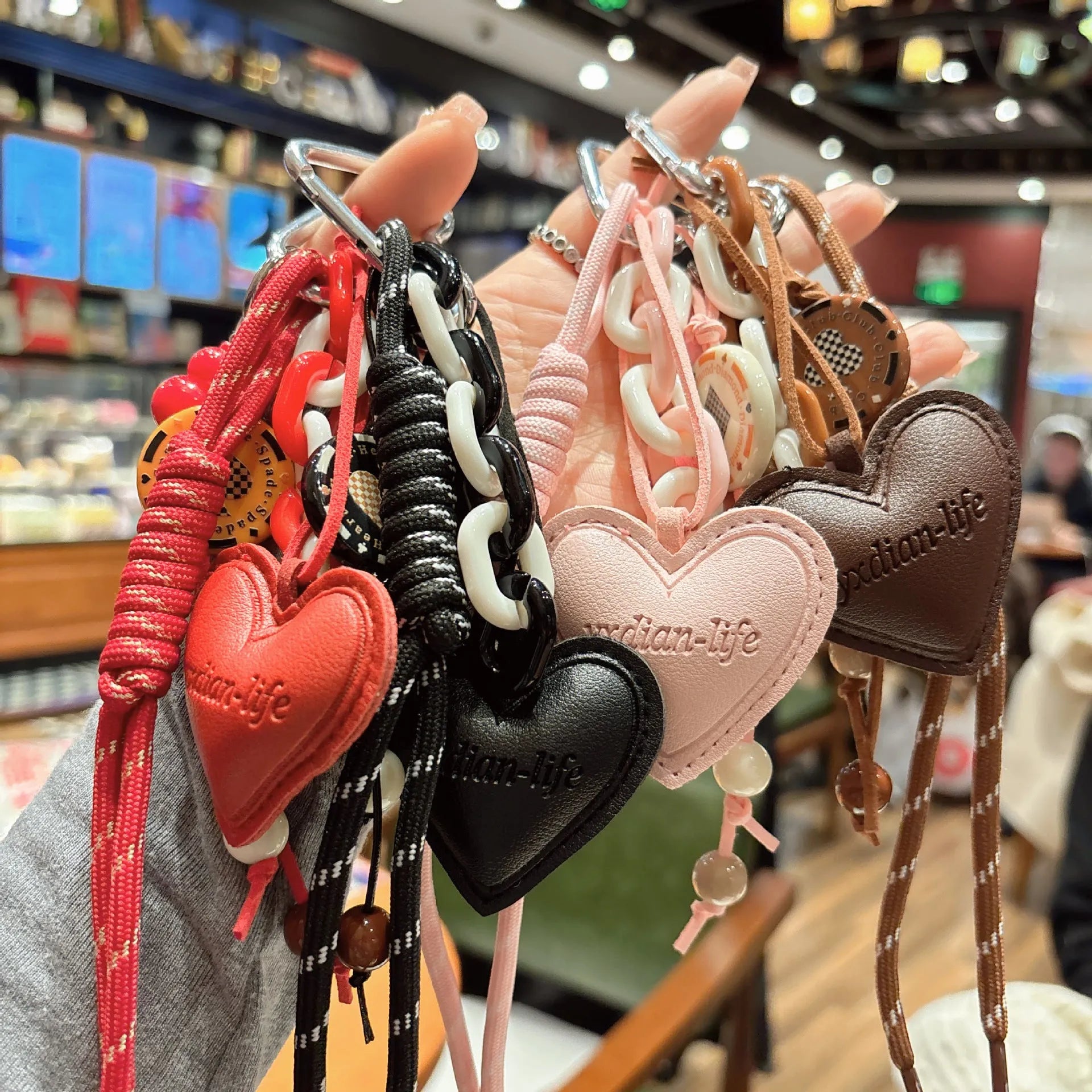 Leather heart-shaped and small gourd pendant keychain with woven rope loop, available in brown, black, pink, red
