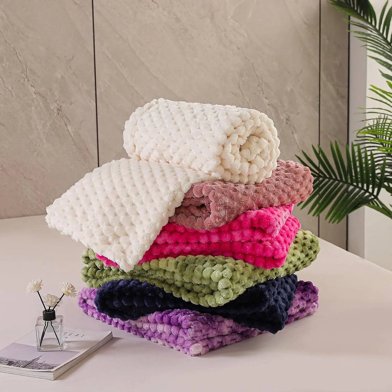 Soft camel-coloured plaid fleece blanket for children folded on a bed.
