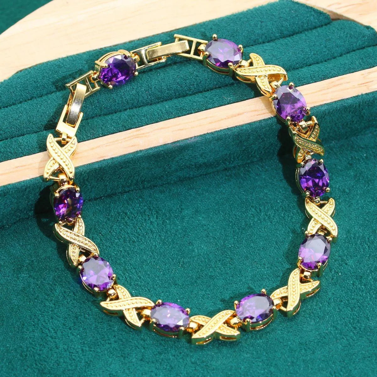Gold plated jewellery set with blue cubic zirconia stones, showing necklace, earrings, ring, and bracelet.
