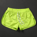 Men's loose fit beach shorts in fluorescent green, orange red, and black colours with micro-elastic polyester fabric