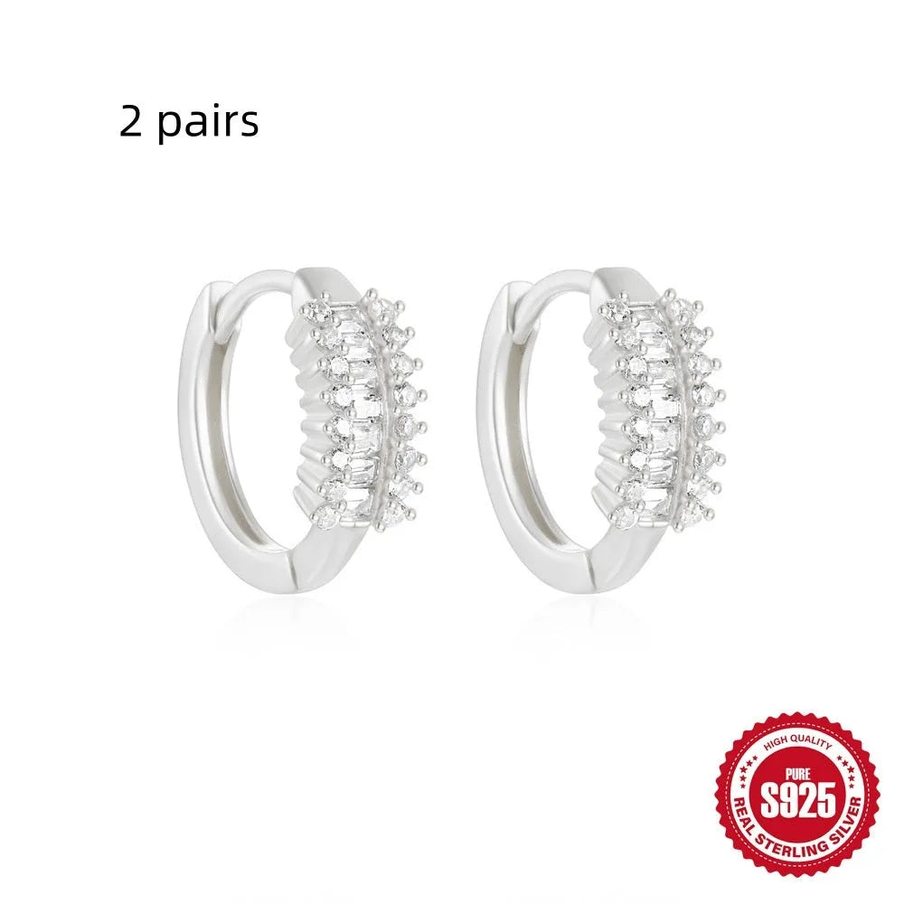 Small round geometric sterling silver stud earrings in gold and silver electroplated finishes.