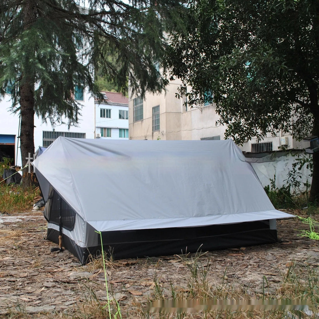 Brown or white A-line hiking tent pitched using hiking canes, showing spacious interior for 2-3 people.