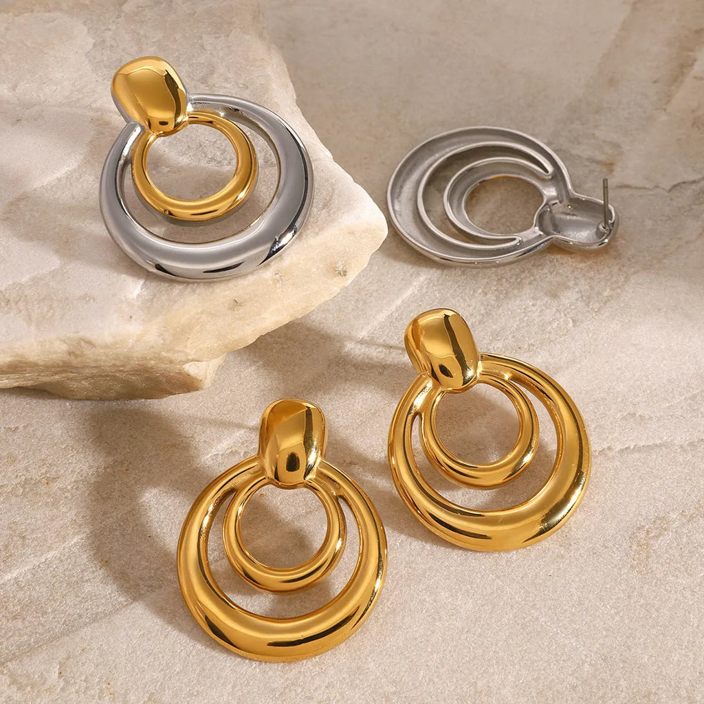 Golden round double layer hollow stud earrings with 18K gold electroplating on titanium steel