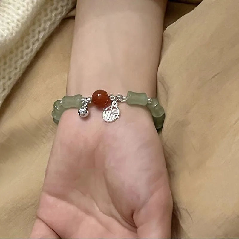 Chinese style glass bracelet with bamboo joint details in a red Lvzhu Duobao design.