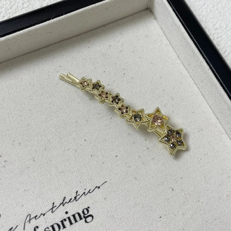 Golden electroplated hair barrette with star decoration and side clip design for bangs