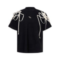 Black loose fit t-shirt with ribbon detailing on padded shoulders, short sleeves, round neck