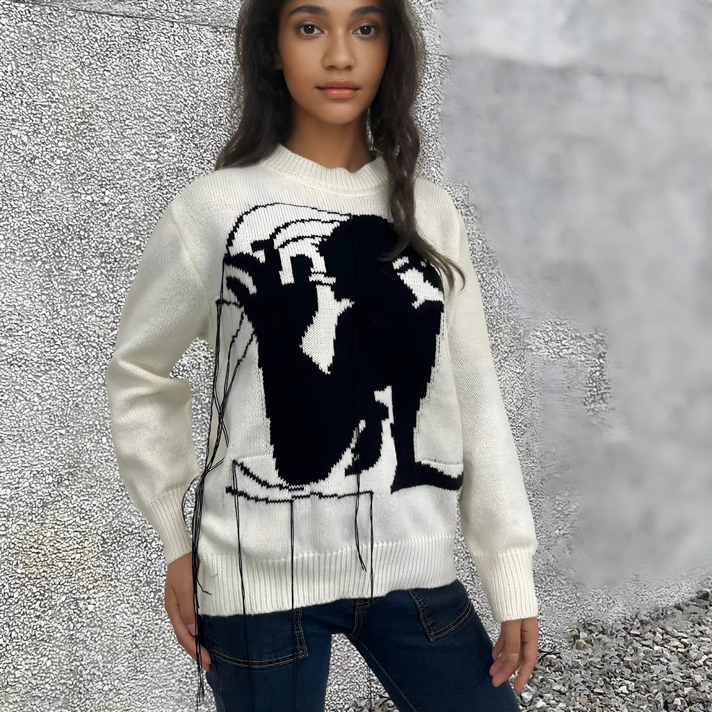 Grey women's loose alpaca wool sweater with tassel detail and abstract pattern, round neck.