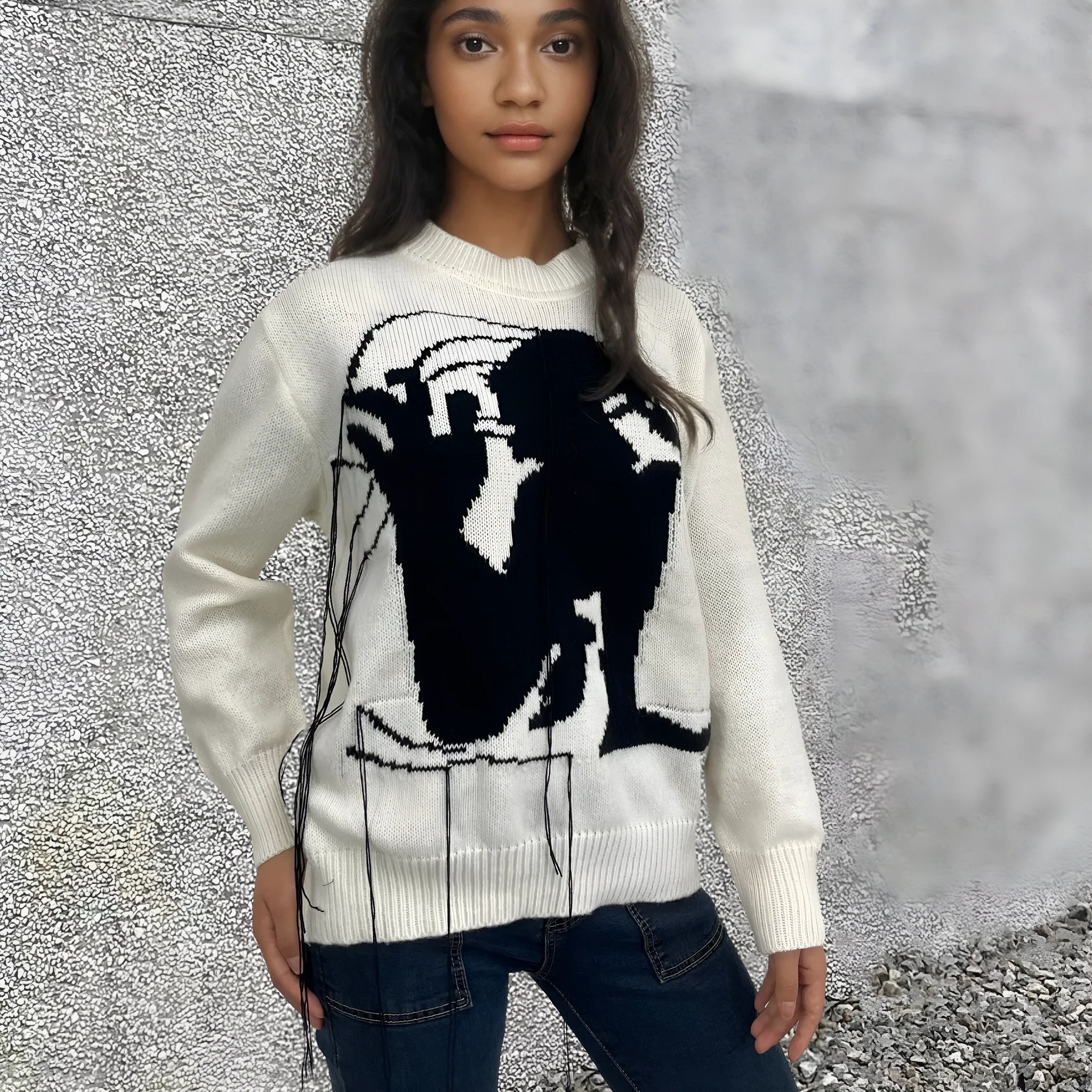 Grey women's loose alpaca wool sweater with tassel detail and abstract pattern, round neck.