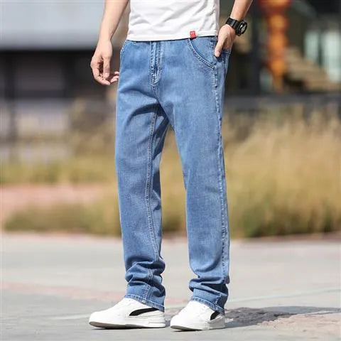 Men's smoky gray straight tube jeans with low waist and zipper fly closure