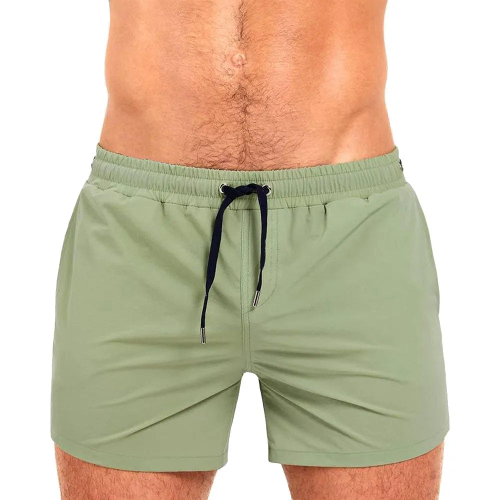 Men's solid colour mesh lining polyester sports shorts for swimming and fitness.