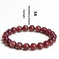 Natural red strawberry quartz crystal bracelet with geometric cut beads, shown in unisex styling.