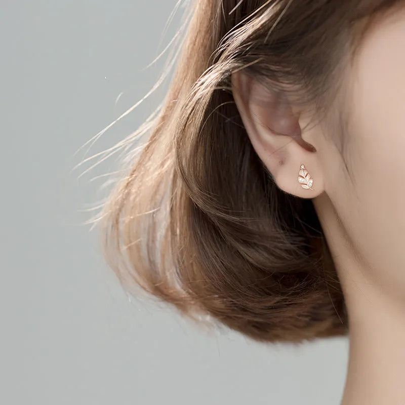 Copper willow leaf stud earrings with micro-inlaid leaf detailing, rose gold or white gold finish, side view on white background