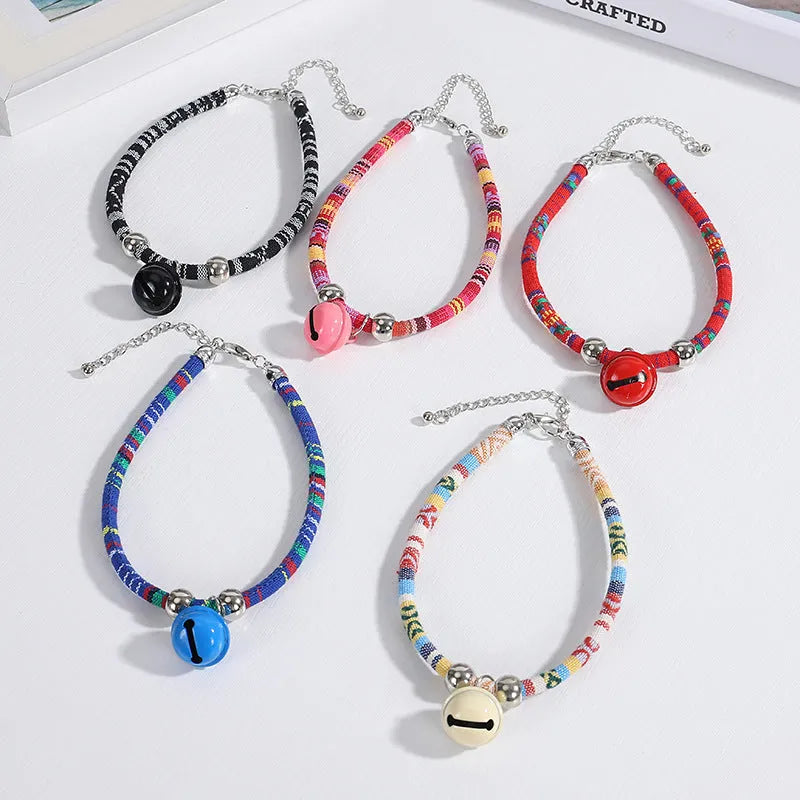 Adjustable pet collar with bell in ethnic pattern, showing colour options: black, blue, pink, red, white.