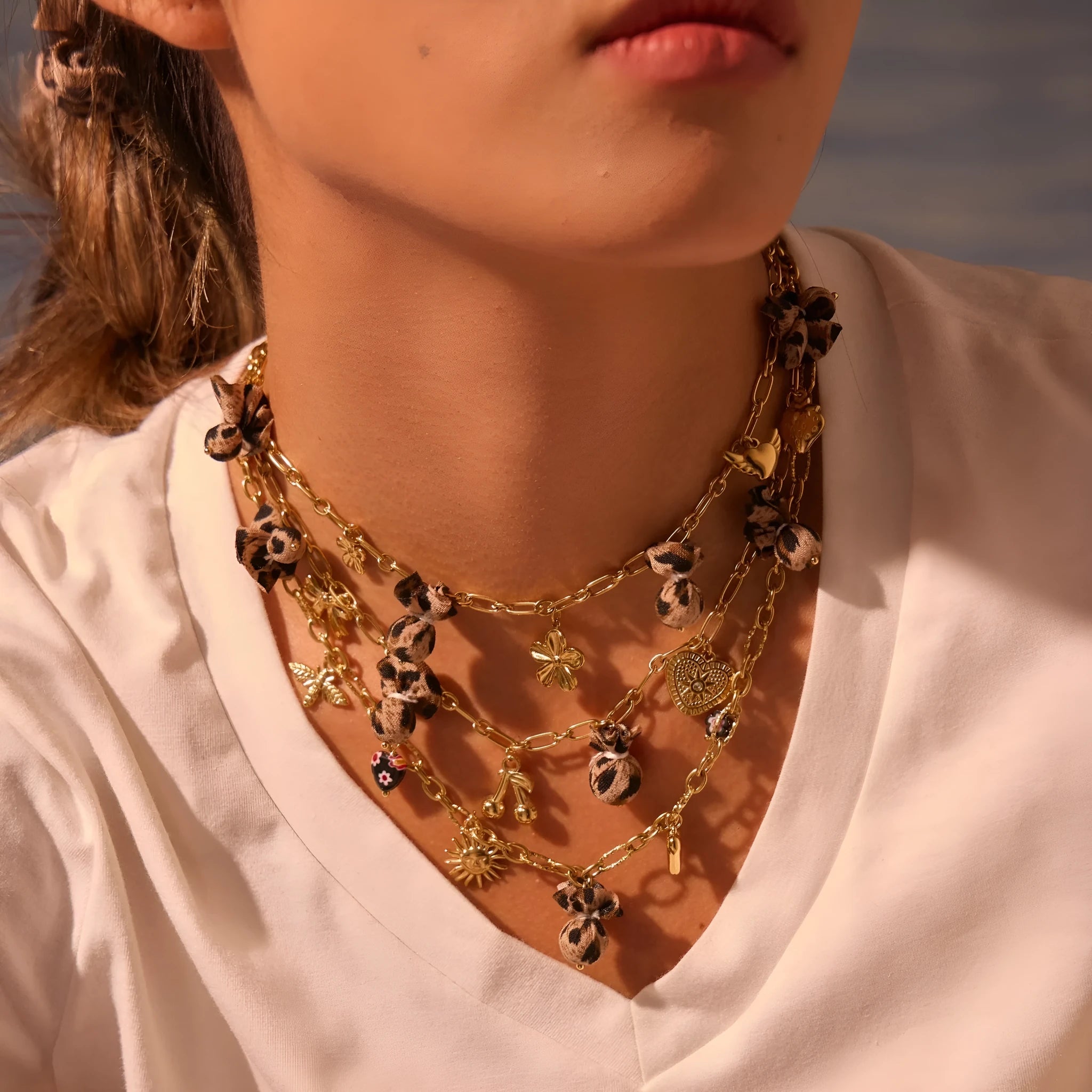 Geometric leopard and heart pendant stainless steel necklace on a model, showing adjustable chain.