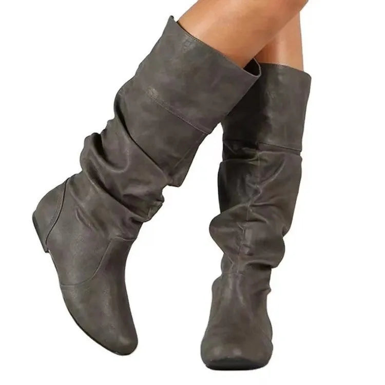 Women's black flat heel long slip-on boots with a round toe and high cylinder length.