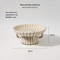Black and white striped synthetic resin fruit plate or dessert plate on a table