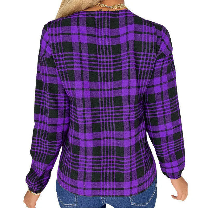 Woman wearing a loose-fit purple plaid casual shirt with regular sleeves.