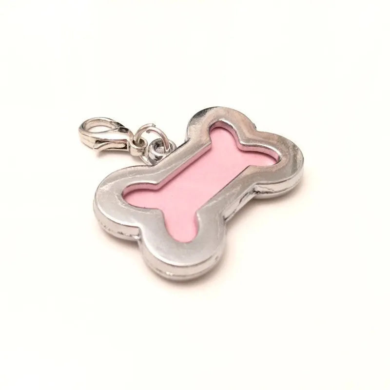 Pink metal dog pendant necklace with bone pattern diamond charm on display