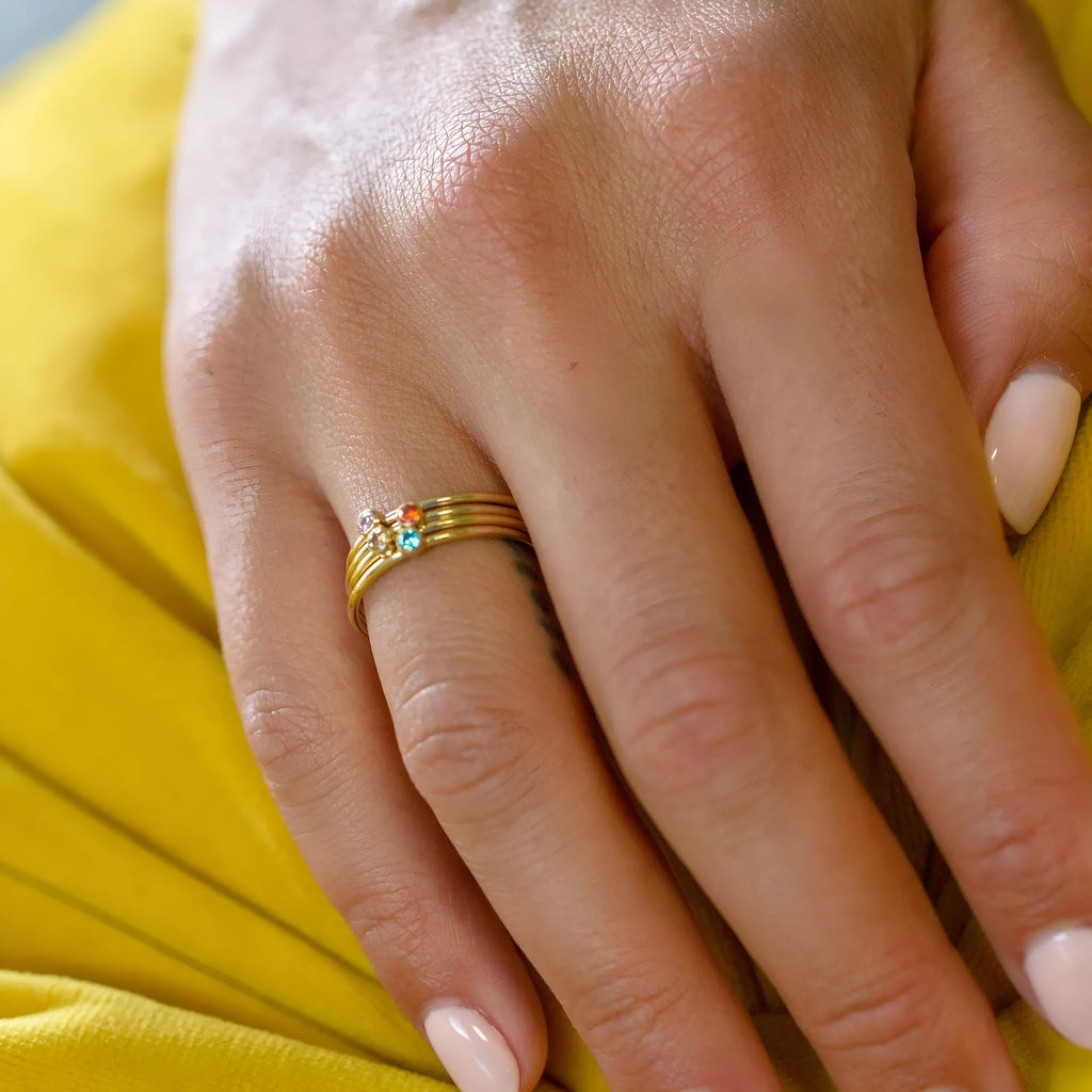 Geometric titanium steel ring with engraved December birthstone design on a hand.