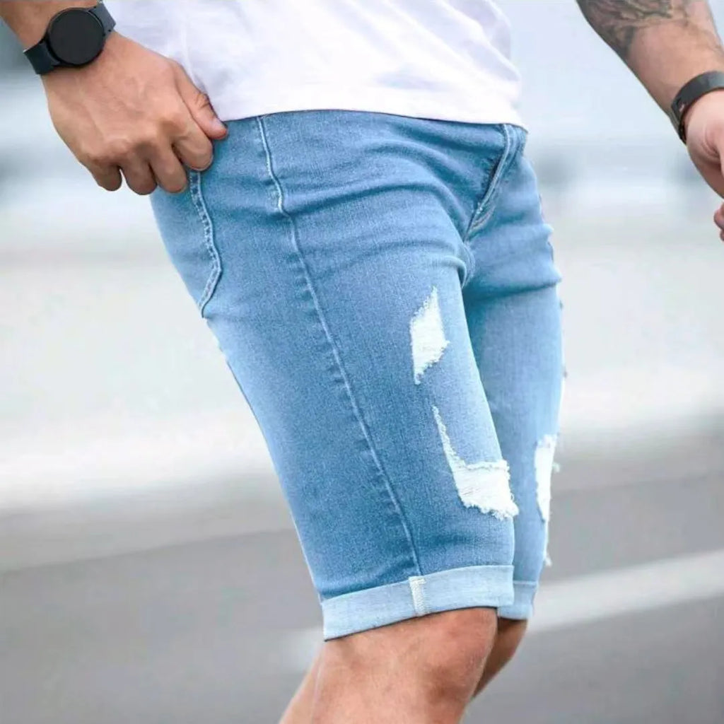 Sky blue denim shorts with distressed holes and low waist design