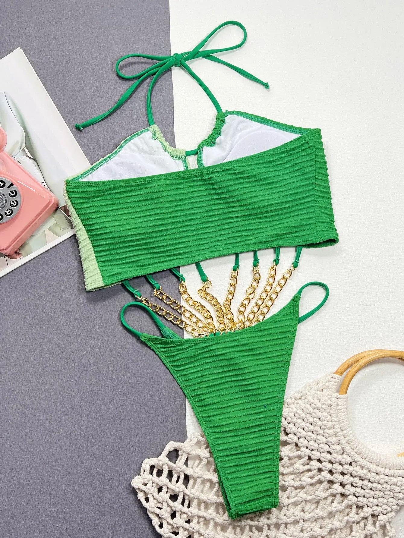 Green women's one-piece swimsuit with hollow cut-out design showing front view