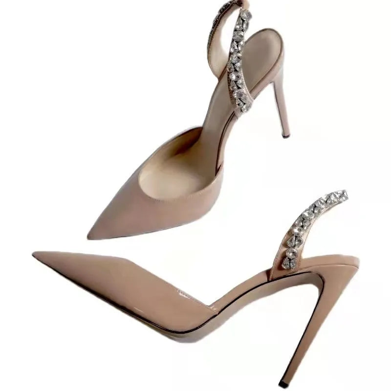 Rhinestone embellished pointed toe high heel sandals in glossy patent leather.