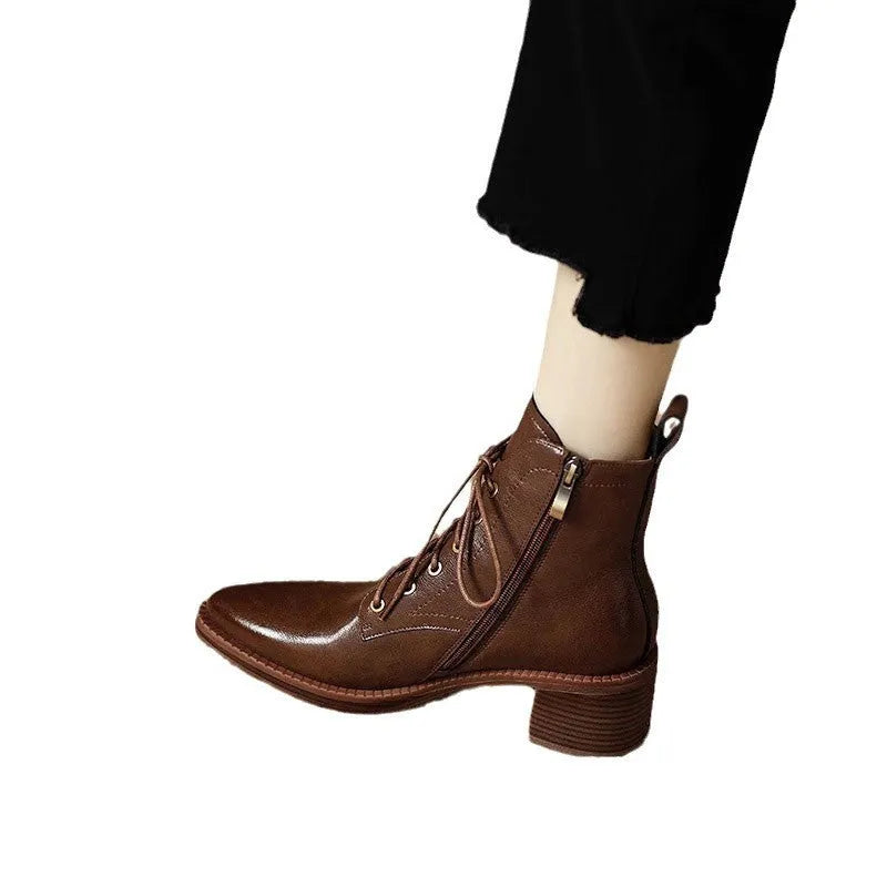 Women's black pointed-toe short tube boots with a 5.5cm heel on a plain background.