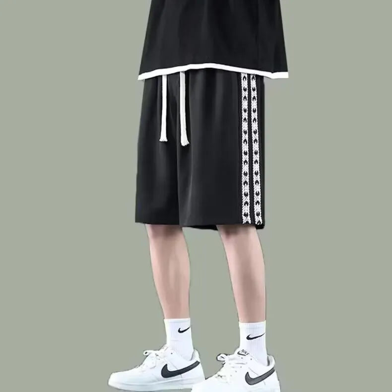 Men's loose black track pants with elastic waistband and baggy leg fit