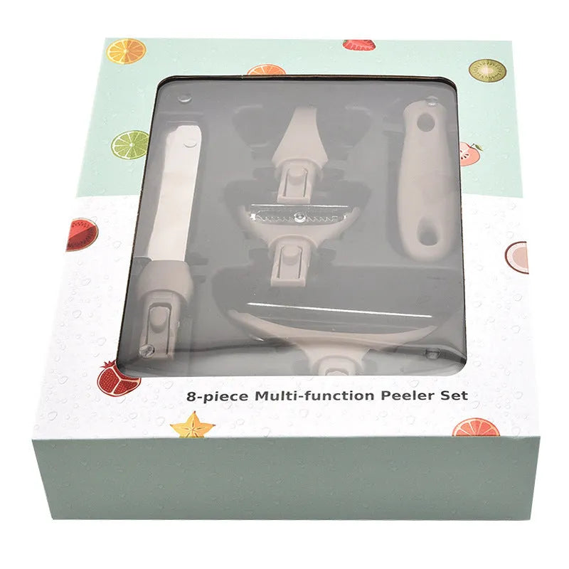 Green stainless steel cutter set with wheat straw chopping board, peeler, and fruit knife on a table
