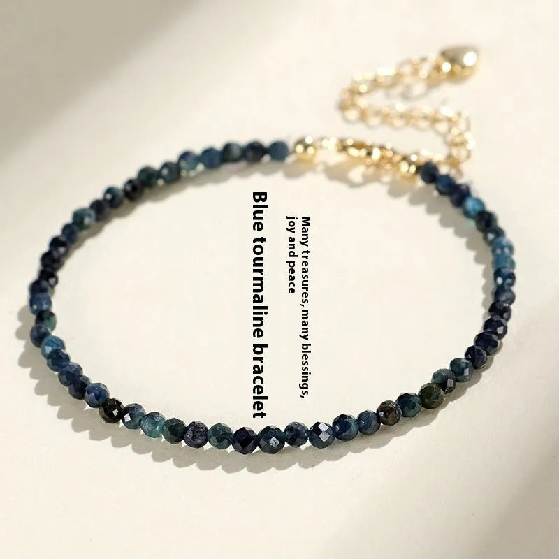 Close-up of a women's blue tourmaline beaded bracelet with 3mm gemstone beads and spacer details.
