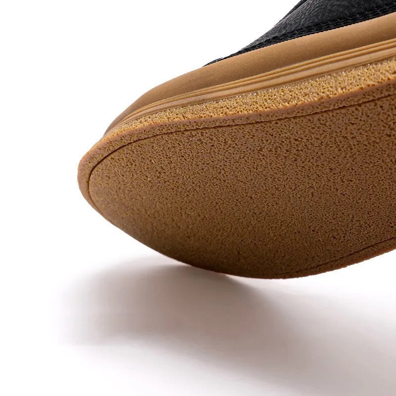 Men's black leather casual shoes with round toe and flat rubber sole on a white background.