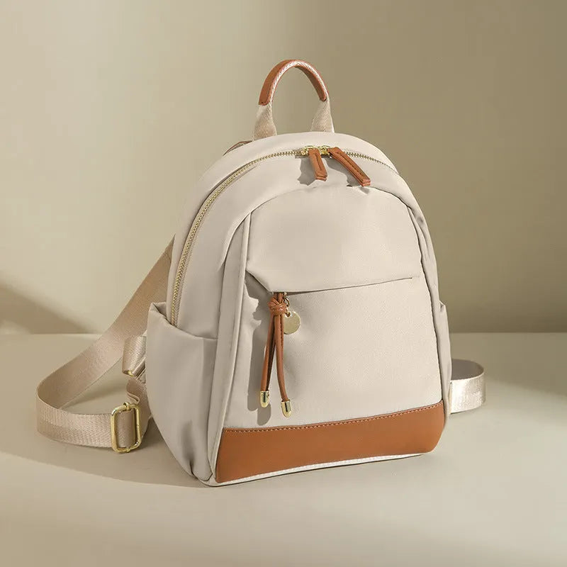 Women's double shoulder Oxford cloth backpack in almond colour with contrast stitching and open outer pocket