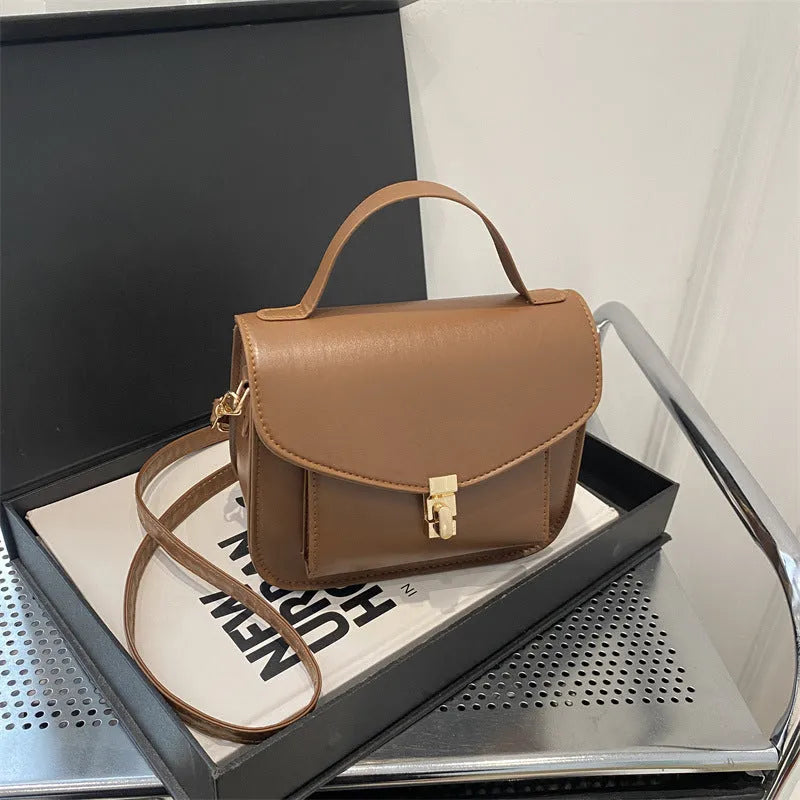 Retro style shoulder messenger bag in horizontal square shape with crossbody strap