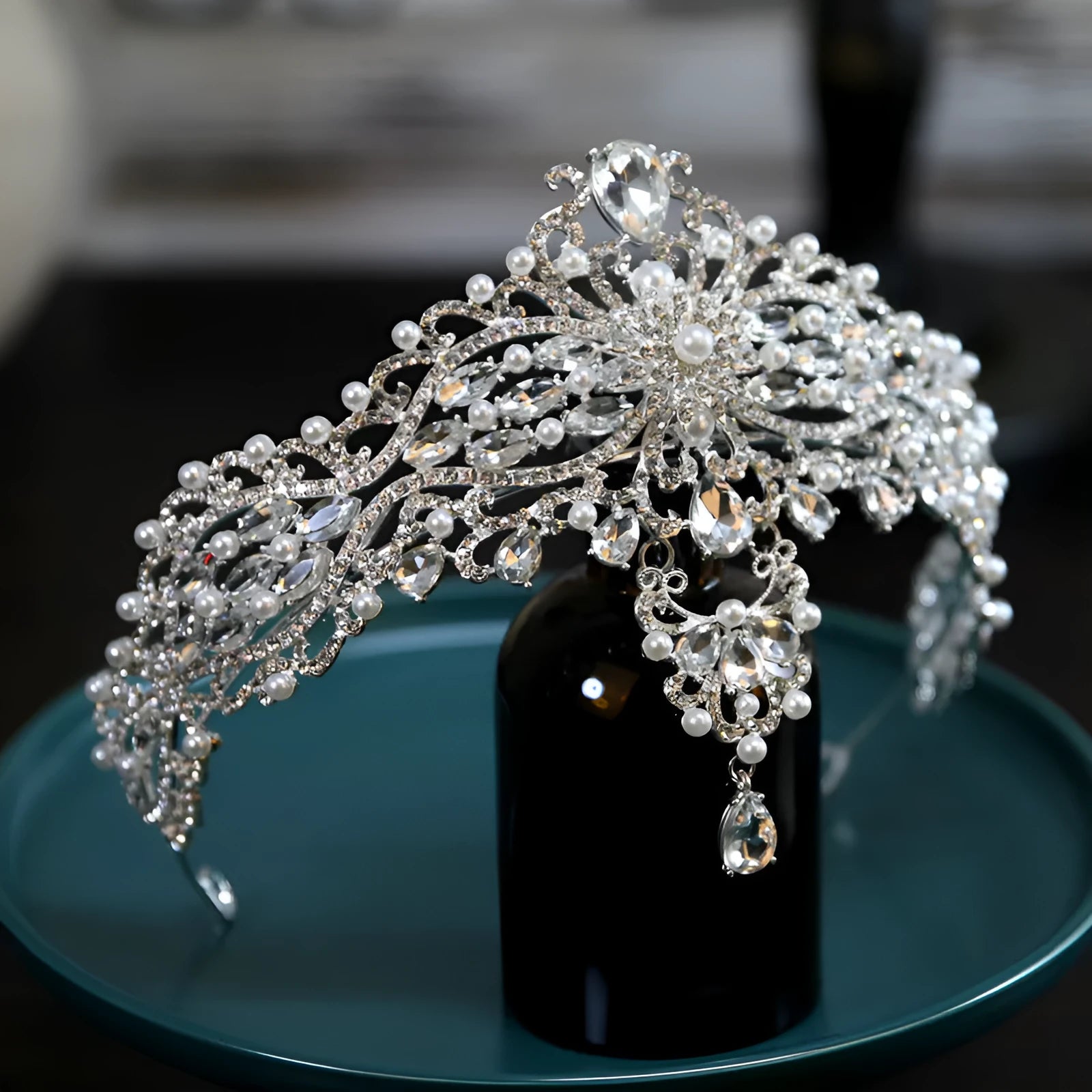 Silver alloy baroque bride crown with pearl and quota decoration on a white background