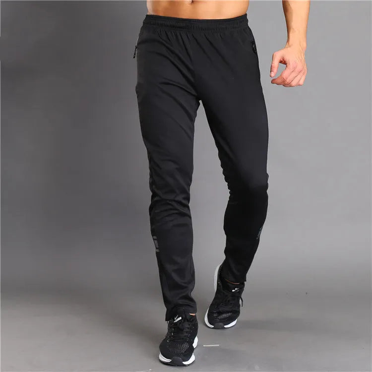 Slim-fit polyester running trousers with colour-changing reflective printing and zip pocket, black, front view