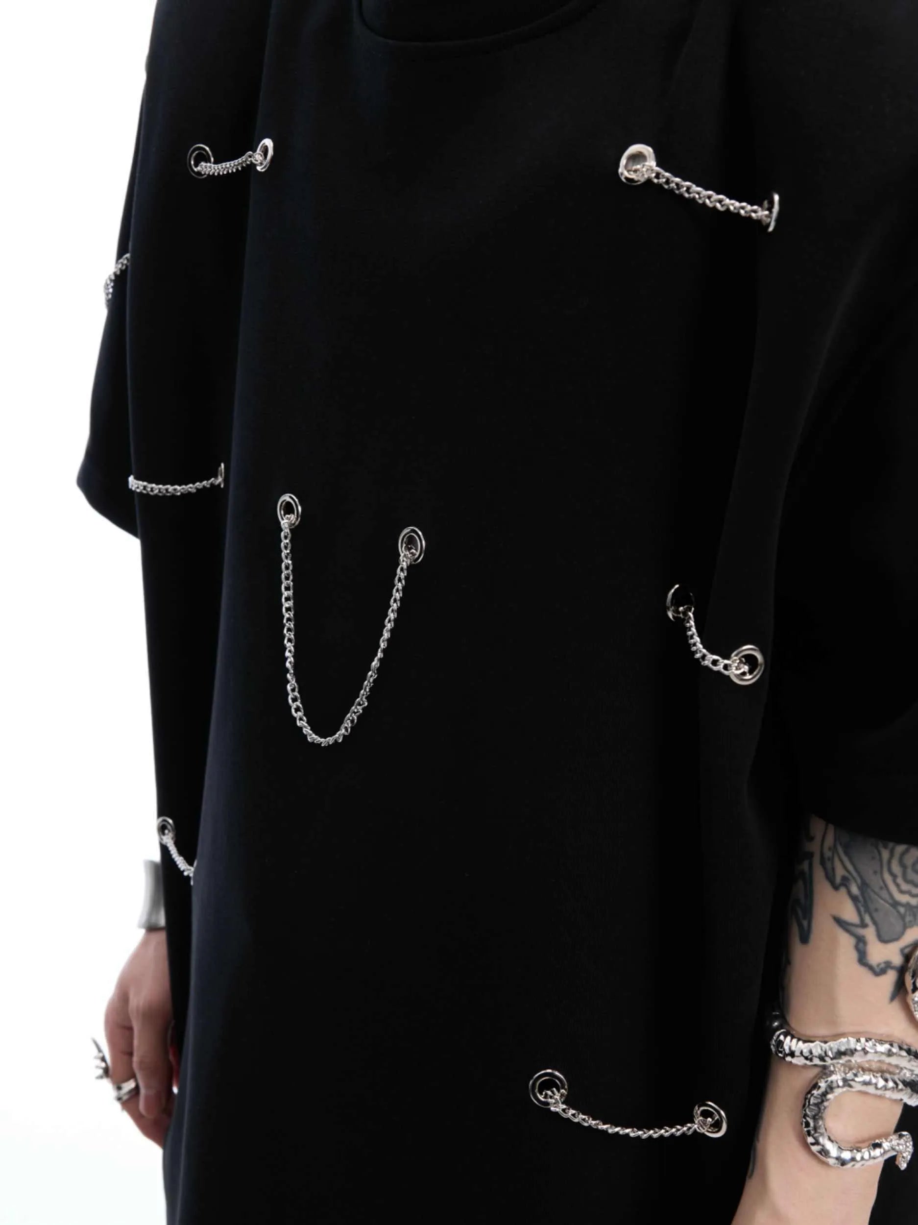Black cotton blend T-shirt with metal chain detail on padded shoulders, short sleeves, round neck, front view