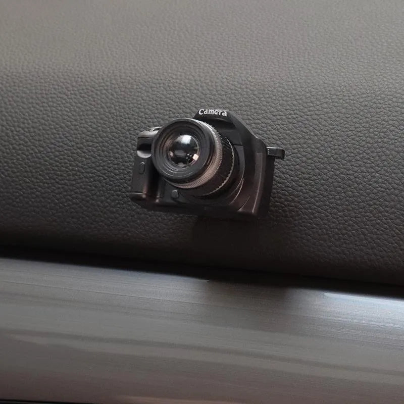 Pack of four retro camera dot design adhesive hooks for car interiors.