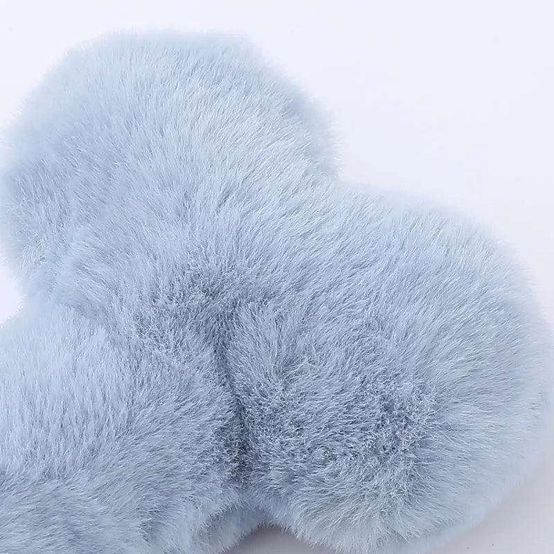 Blue plush love bone dog toy with a vocal element for interactive chewing and play.