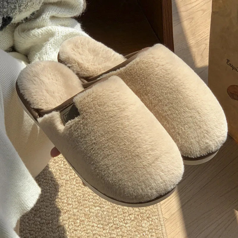 Solid colour PVC plush winter house slippers on a wooden floor.