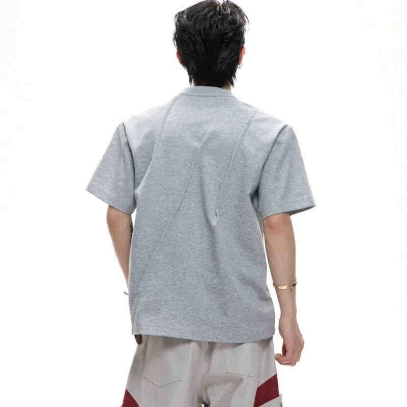 Men's grey cotton T-shirt with pleated detail and a round neck on a hanger.
