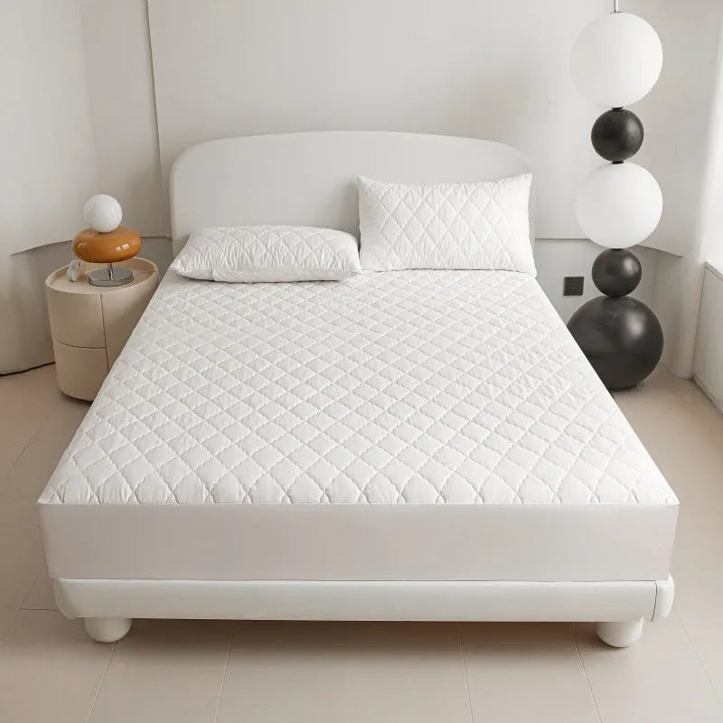 Diamond lattice quilted waterproof mattress protector and pillowcases in a solid colour.