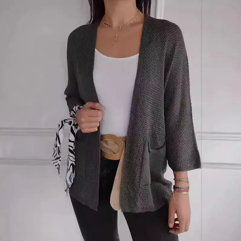 Women's army green waffle weave cardigan coat with nine-quarter length sleeves and pockets.