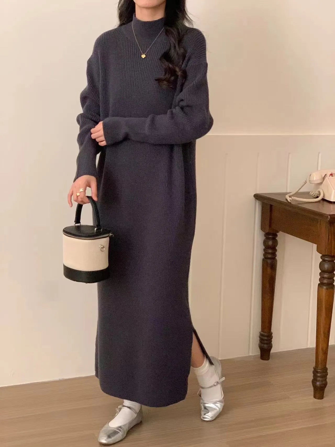 Women's knitted half turtleneck dress in acrylic with long sleeves and a high-waisted midi skirt.