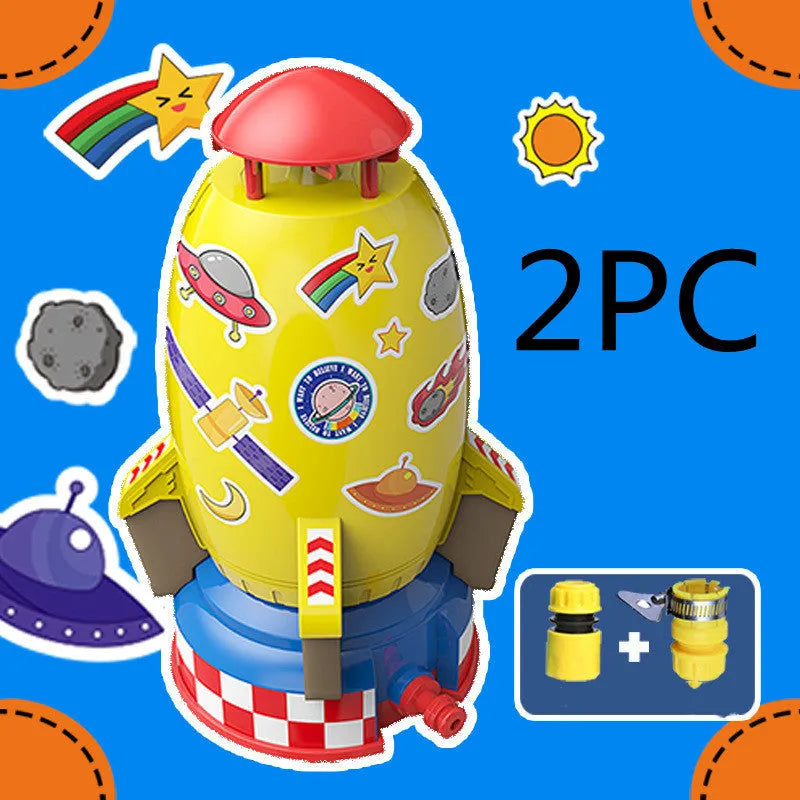 Water pressure rocket launcher toy on green grass with water spray, yellow rocket, and base connector