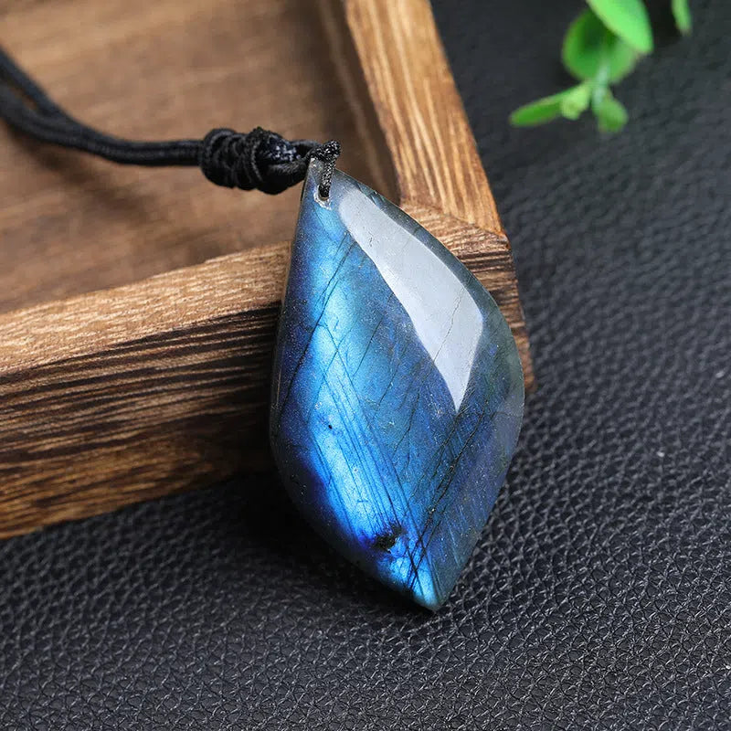 Natural labradorite leaf pendant necklace with blue moonlight effect on white background