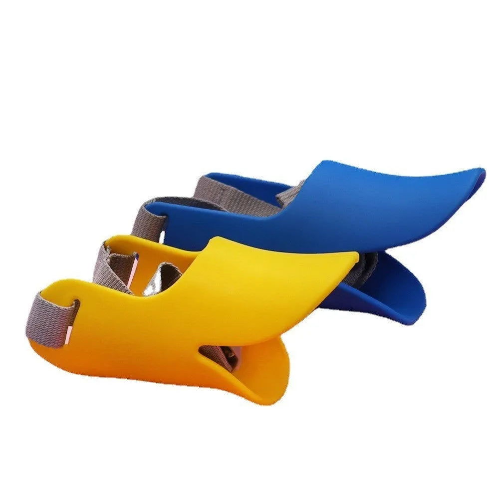 Silicone duckbilled dog muzzle in yellow on a small dog with adjustable strap