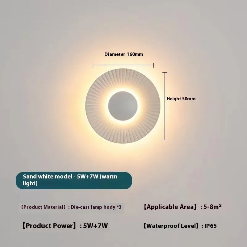Round aluminium LED wall lamp in a dual-colour finish mounted on a wall.