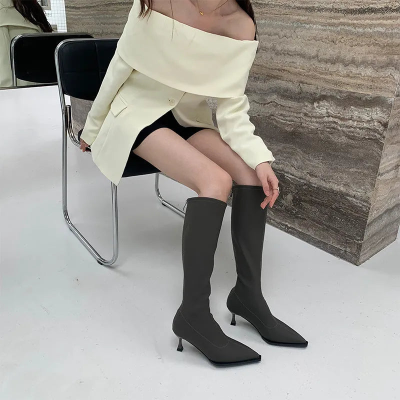 Women's black pointed toe stiletto heel boots with a back zip closure