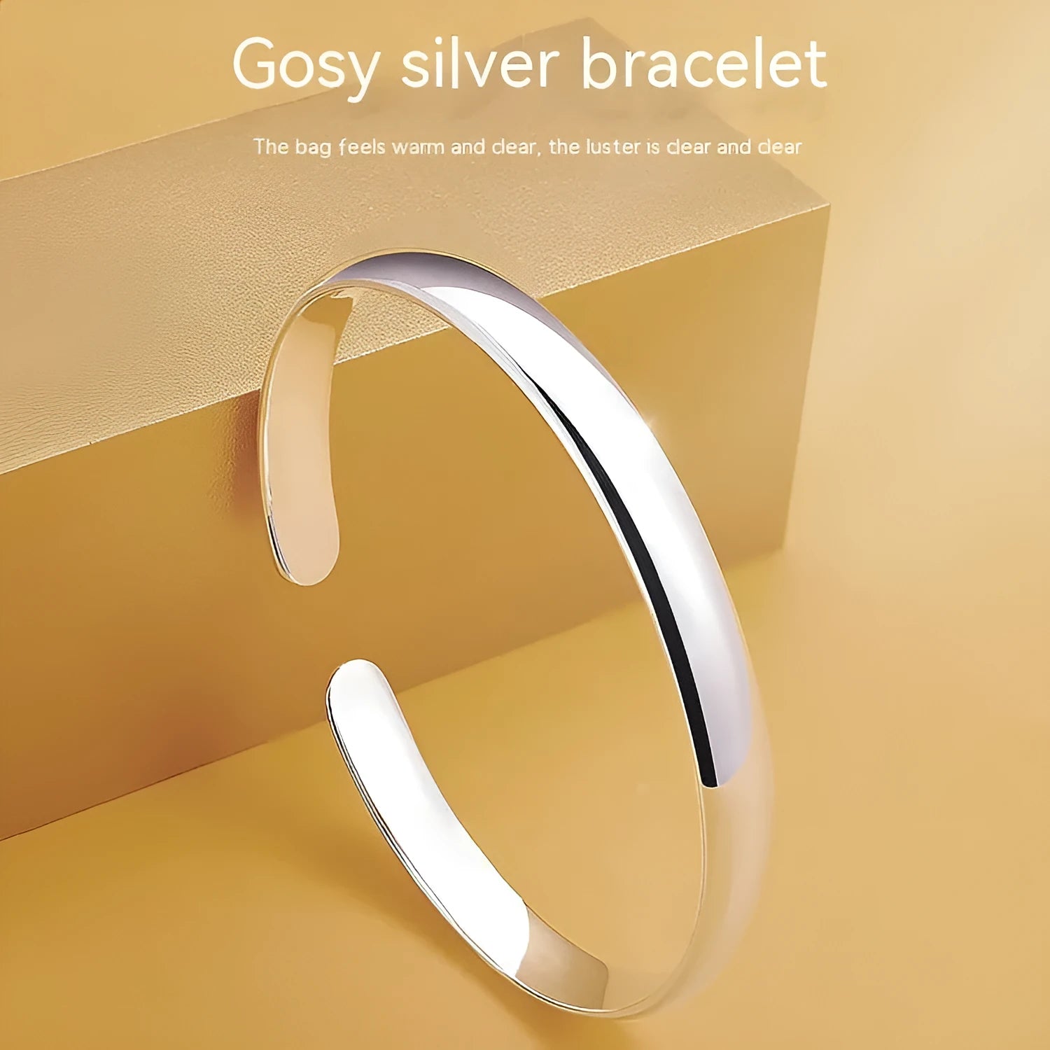 Glossy silver-plated copper bracelet with Ruyi and lucky cat charms on white background