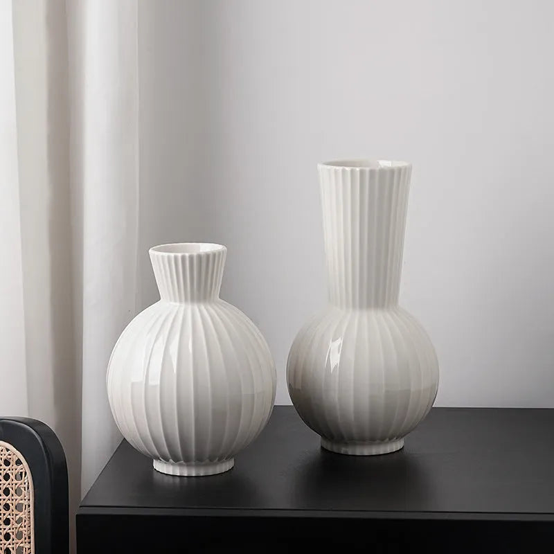 White ceramic ball vase with striped patterning in American country style on wooden table